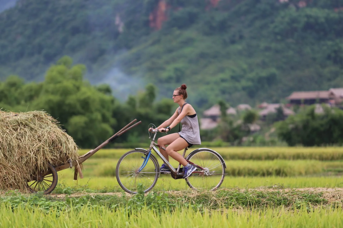 Tourist biking around Nam Dam Village in Ha Giang